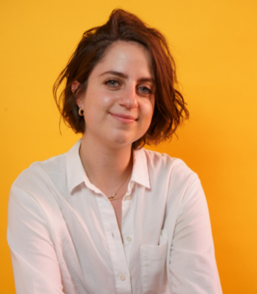 A headshot image of Andrea Becker in front of an orange background