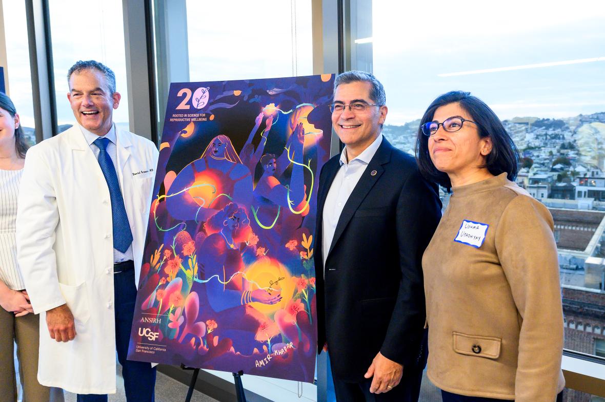 ANSIRH Director Dr. Daniel Grossman, Sec. Xavier Becerra, and Dr. Ushma Upadhyay pose for a photo in front of ANSIRH's 20th anniversary poster.
